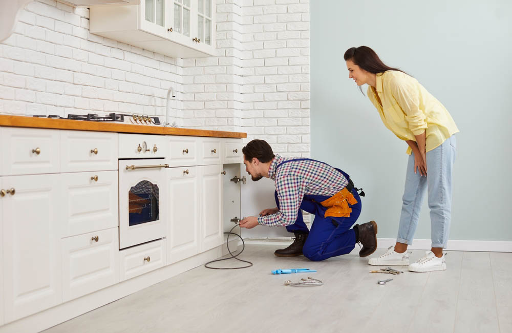 plumber using drain cable to unclog sink Phoenix, AZ