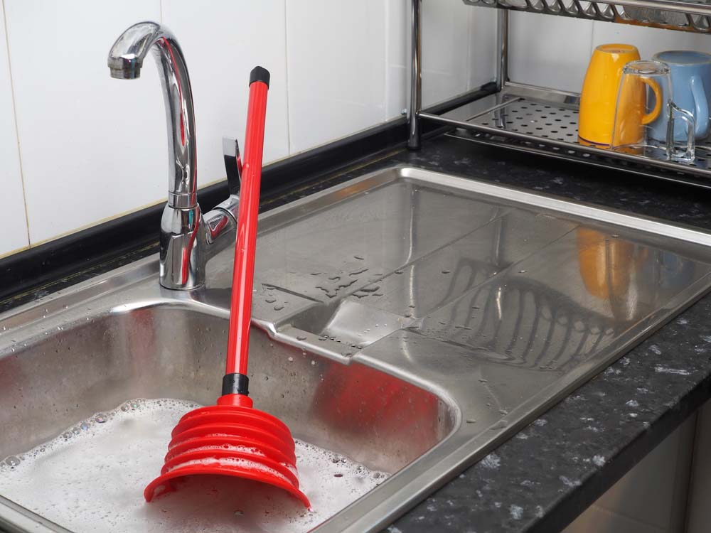 clogged sink with red plunger Scottsdale, AZ