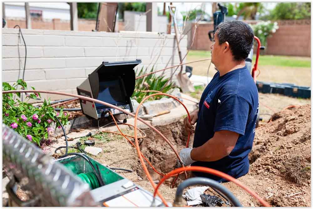 plumber checking the live feed from the pipe camera Scottsdale, AZ