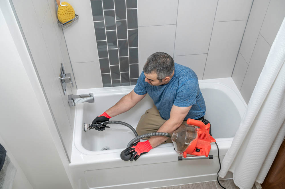 drain snaking tools being used by a plumber Scottsdale, AZ