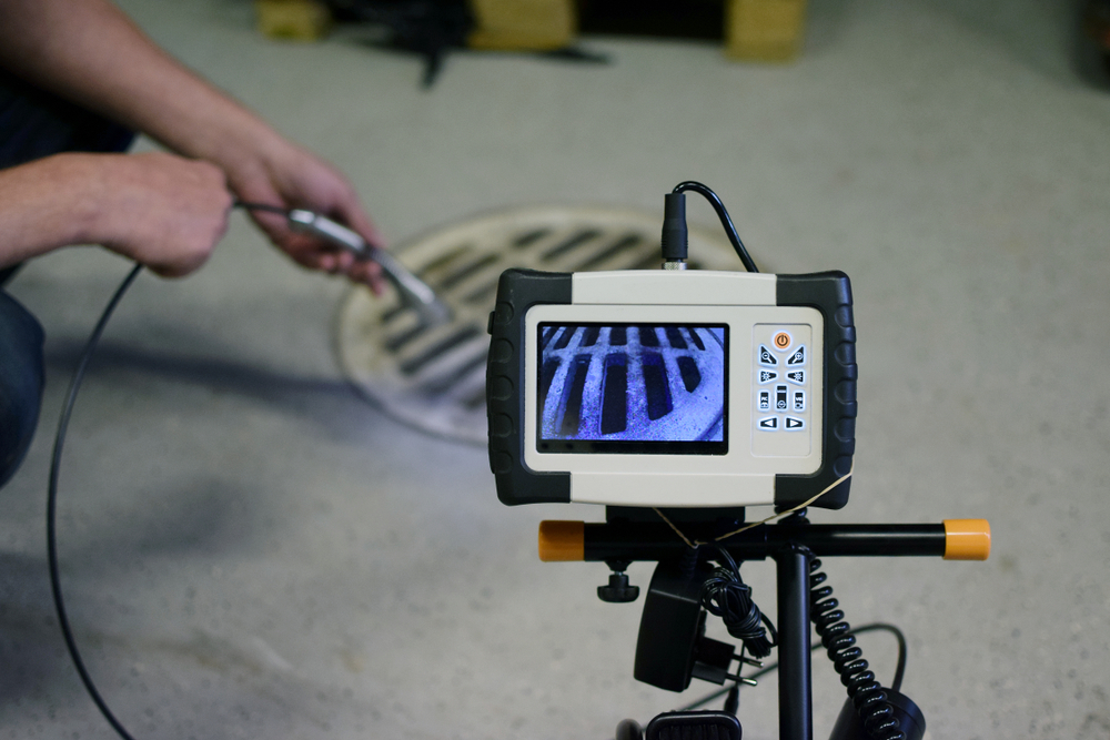 A high-definition sewer camera head resting inside a pipe