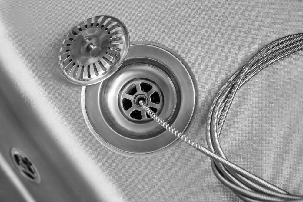 drain snake clearing kitchen sink