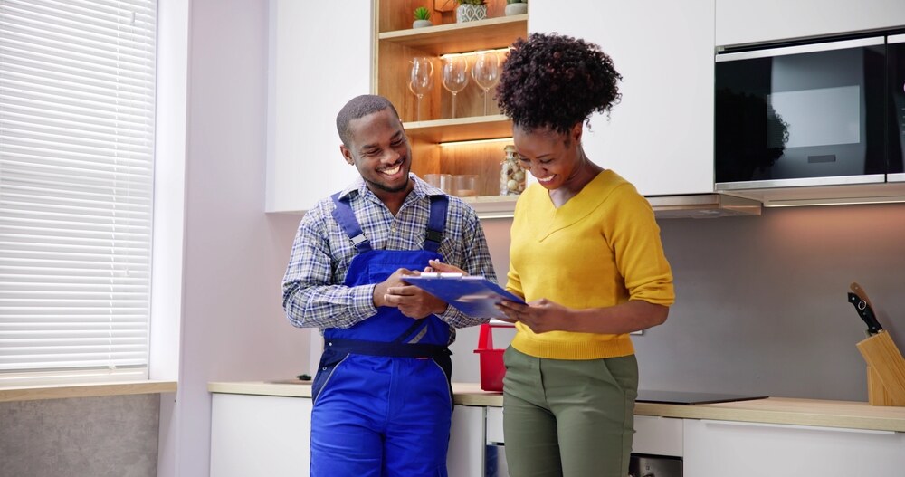 technician and homeowner reviewing service clipboard