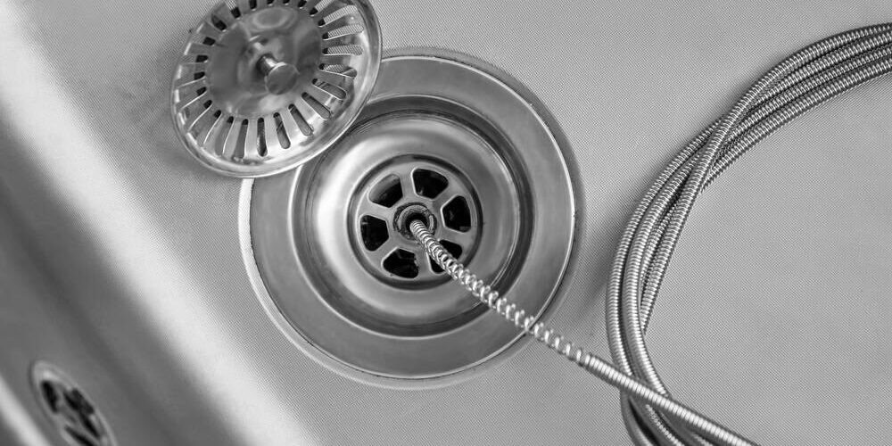 drain snake clearing kitchen sink