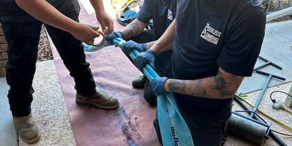 A technician preparing a NuFlow epoxy liner for installation.